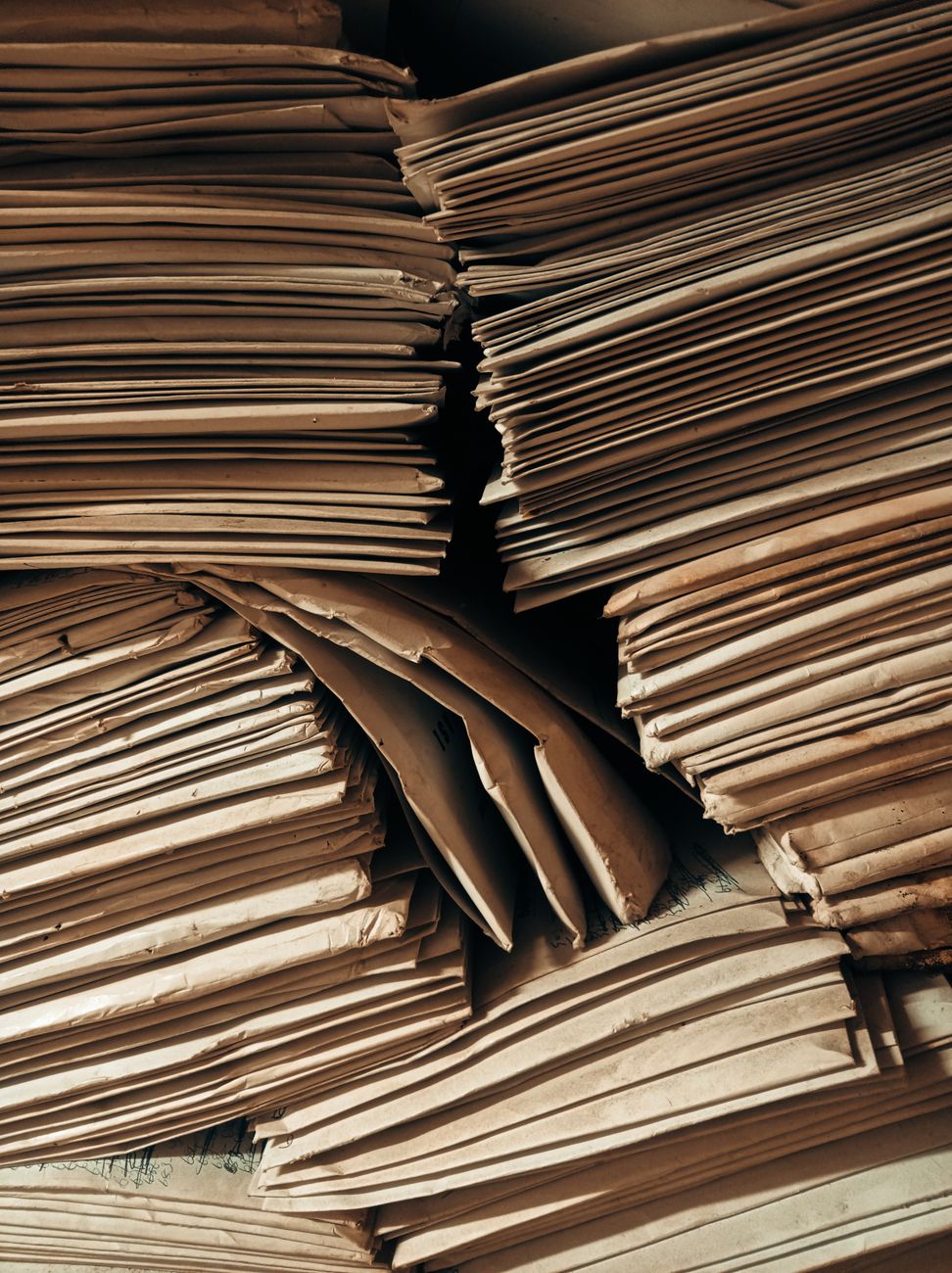 Stacked paper files and cardboard folders